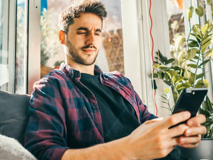 Man Waiting For A Response on A Sofa