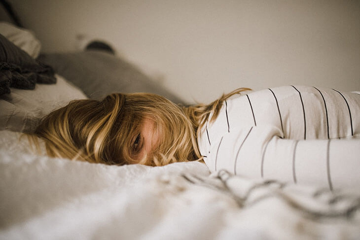 Overwhelmed Woman Lying on Bed