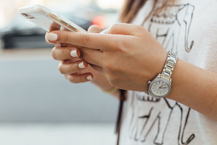 Woman Texting on an iPhone