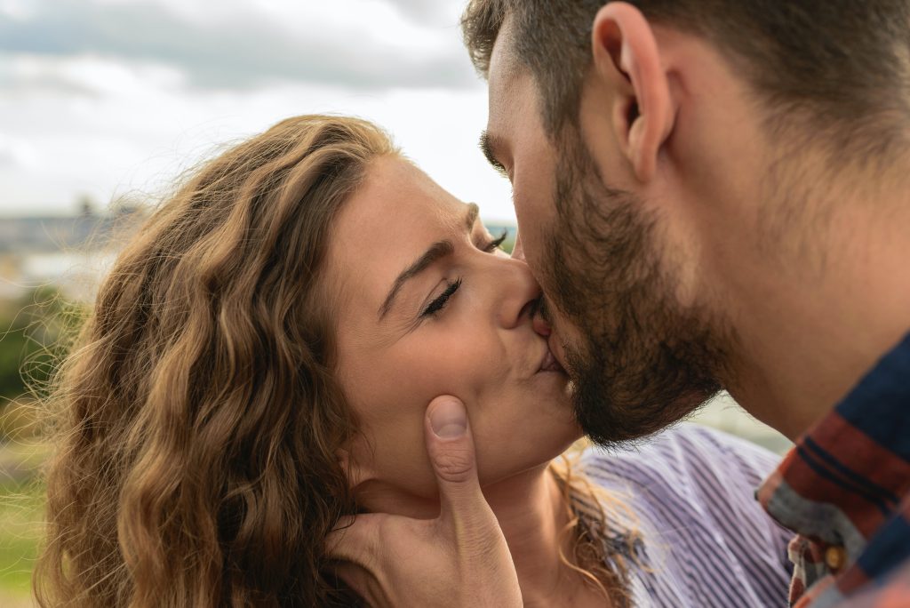 A happy couple kissing each other.