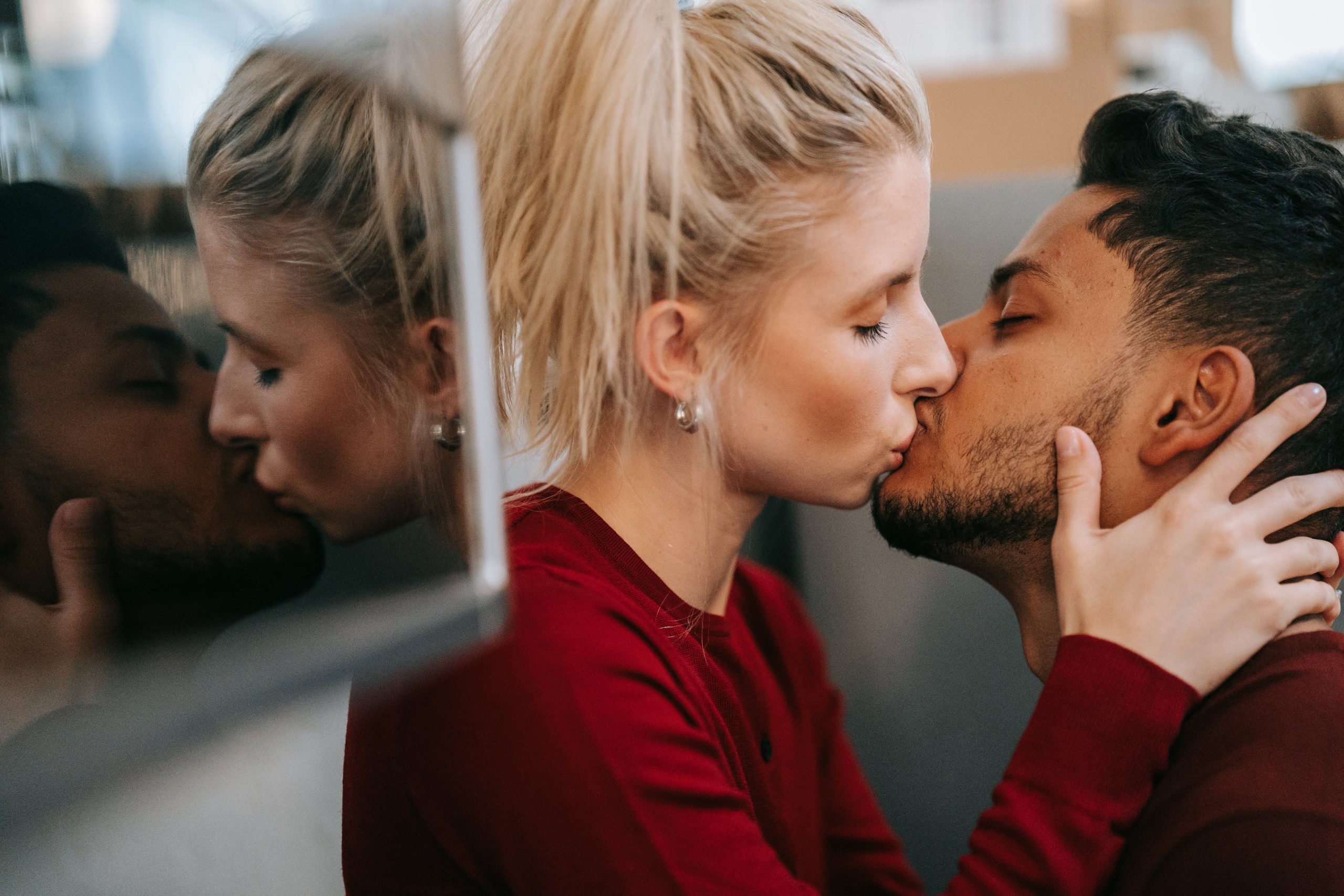 A couple kissing in a car outdoors