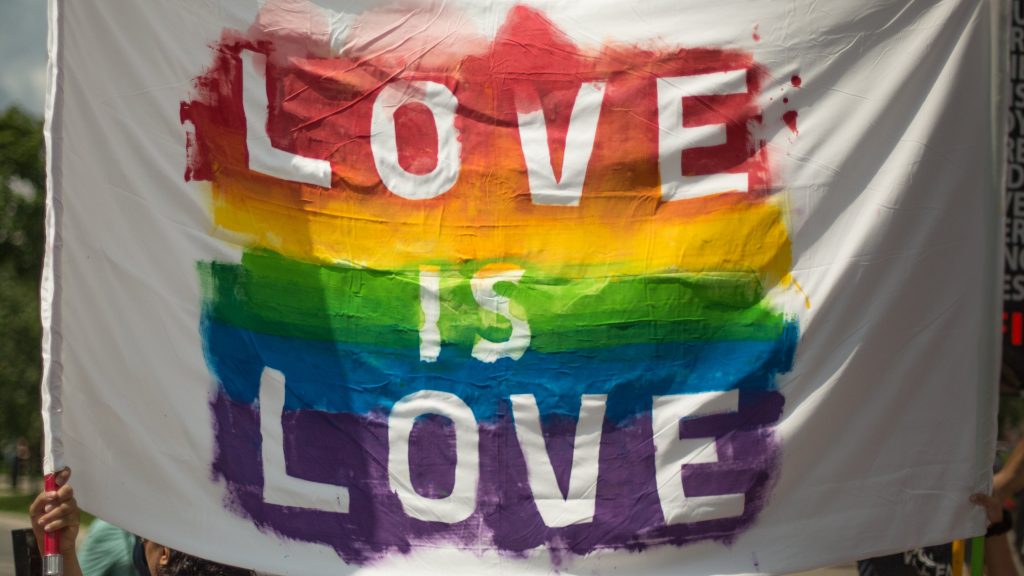 A rainbow flag that says love is love