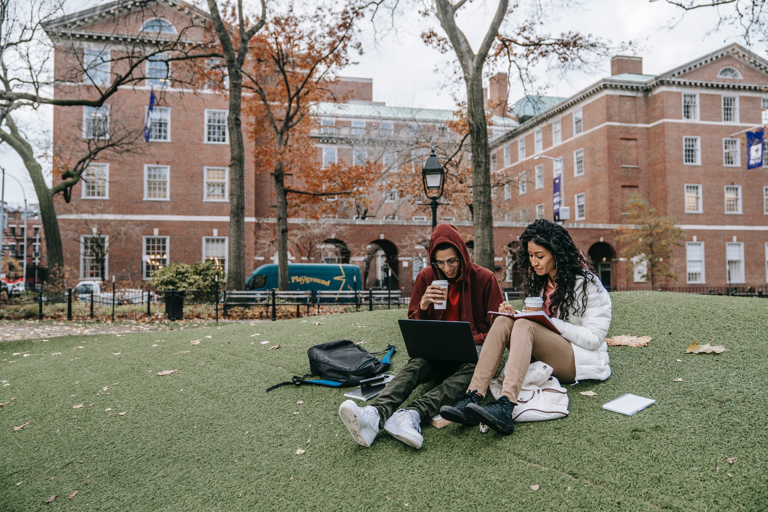 Two college students having a date on the school lawn