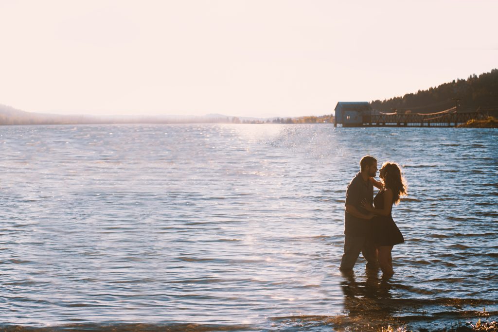 Falling in love with someone new after divorce, embracing each other while walking on the beach with the sea water at your feet.